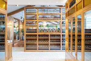 a wine tasting room with a wall of wine bottles at Lion & Swan Hotel in Congleton +17 photos