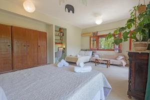 a living room with a bed and a couch at Casa Dentraki in Corfu