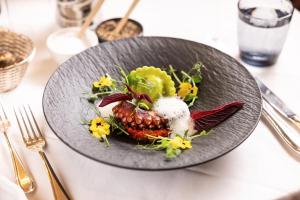 a plate of food with a pineapple on a table at Hotel Bristol Salzburg in Salzburg