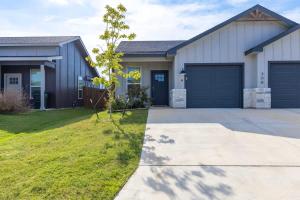 a house with a garage and a driveway at NEW Temple 12 BD Contractor & Group Friendly in Temple