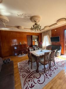 a dining room with a table and a couch at The Bondo's Villa in Kobuleti +41 photos