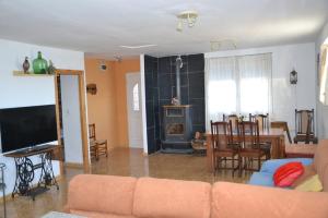 a living room with a couch and a table and a fireplace at Casa Rural Singra in Singra