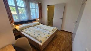 a small bedroom with a bed and a window at Marienburg Castle in Wikon