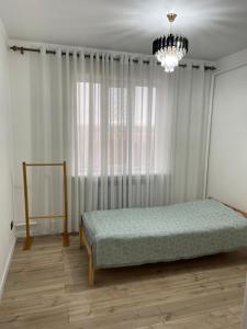 a bedroom with a bed in front of a window at Guest house Sayak in Bokonbayevo +12 photos