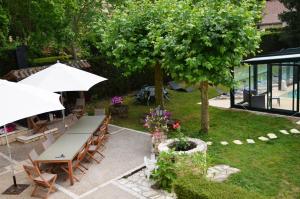 an overhead view of a patio with a table and umbrella at Le Logis du Port in Domme +10 photos