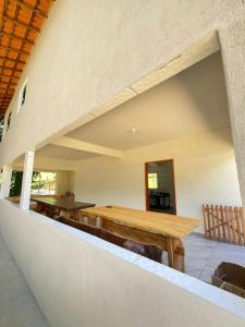 a dining room with a wooden table in a building at Lago Camping Sana in Macaé