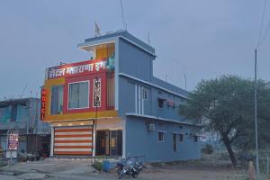 a building with a motorcycle parked in front of it at Hotel Maharana Inn in Sehore