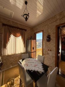 a dining room with a table and a refrigerator at The Bondo's Villa in Kobuleti