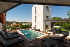 a house with a swimming pool on a deck at Villa Bellavista in Medulin