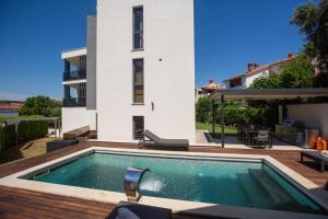a swimming pool in front of a house at Villa Bellavista in Medulin