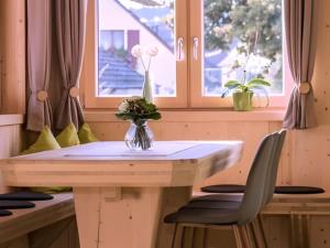 a table and chairs in a room with a window at Saunaloft Schwarzwald - privater 45qm Saunabereich - großzügige Räume mit viel Ruhe in Gemeinde Aichhalden +31 photos