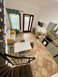a living room with a white table and chairs at Casa IXI in Santadi