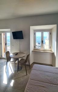 a bedroom with a bed and a table and a tv at Borgo Marchetti in Camerano