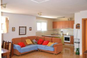 a living room with a couch with red and yellow pillows at Casa Rural Singra in Singra