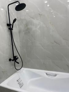 a shower in a bathroom with a white tub at Guest house Sayak in Bokonbayevo