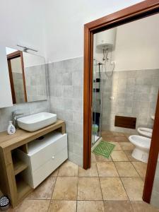 a bathroom with a sink and a toilet and a shower at Casa IXI in Santadi +21 photos