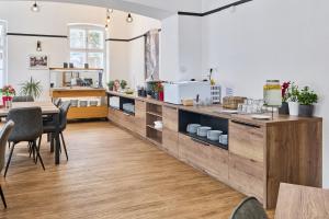 a kitchen with a counter with a table and chairs at Hotel Terra in Janske Lazne