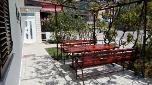 two red benches sitting next to a building at Room Rosa in Senj