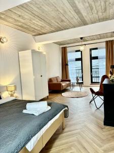 a bedroom with a bed and a living room at Apartamenty Staszica in Bielsko-Biała