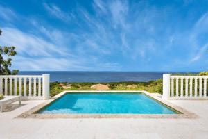 a swimming pool with a view of the ocean at Villa El Rincon 637 - Coral Estate in Willibrordus