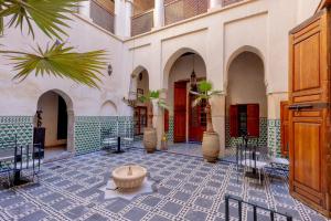 a courtyard with a fountain in the middle of a building at Riad Sarasvati & SPA in Marrakesh