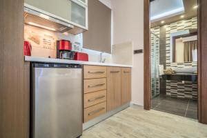 a kitchen with a stainless steel refrigerator and a sink at Nikos & Maria Studios in Laganas