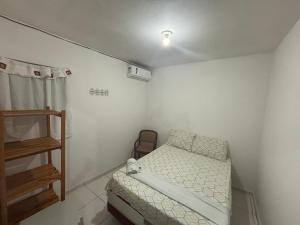 a small room with a bed and a ladder at Apartamento in Maragogi