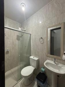 a bathroom with a toilet and a sink and a shower at Apartamento in Maragogi