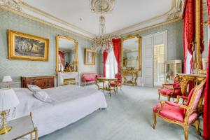 a bedroom with a bed and a table and chairs at Château Optical Center in Nieuil