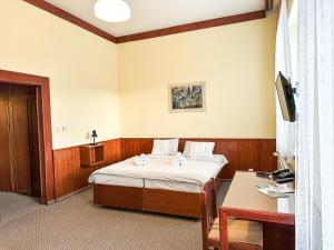 a hotel room with a bed and a table at Réva in Janske Lazne +30 photos