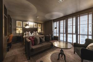 a living room with a couch and a table at Dakota Glasgow in Glasgow +51 photos