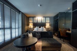 a hotel room with a bed and a couch and a table at Dakota Glasgow in Glasgow
