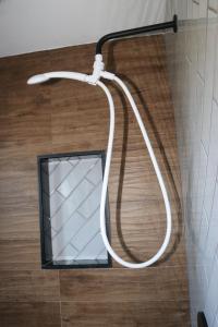 a shower head with a mirror in a bathroom at An Apartment for You to Relax - B in Uniondale +24 photos
