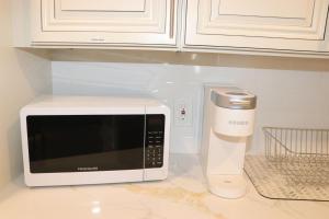 a kitchen counter with a microwave and a hair dryer at An Apartment for You to Relax - B in Uniondale