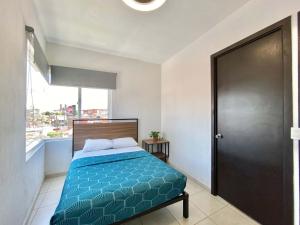 a bedroom with a bed and a large window at Casa Zapopan Hotel in Guadalajara +17 photos