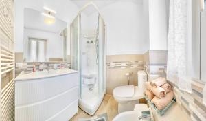 a white bathroom with a toilet and a shower at New Apartment Piombino wifi parking in Piombino +22 photos