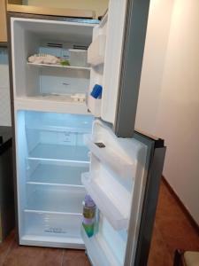 an empty refrigerator with its door open with its door open at La Pinta Càlida casa en Malvìn con cochera in Montevideo