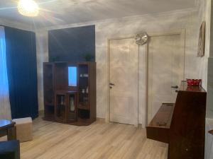 an empty living room with a door and a table at Skyview House Tbilisi in Tbilisi City