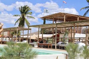 a resort with a swimming pool and a building at Amagali Beach Club in Galinhos