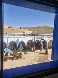a view of a beach from a window at Hôtel grand Atlas in Mirleft