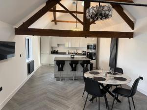 a kitchen and dining room with a table and chairs at Sandstone Grange in Albrighton