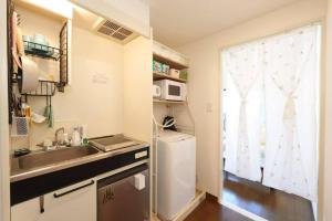 a small kitchen with a sink and a window at sakura 601 in Tokyo