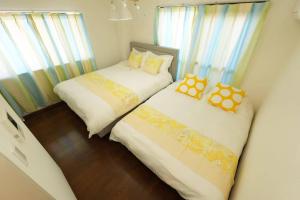 two beds sitting next to each other in a room at sakura 601 in Tokyo +8 photos