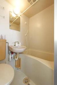 a bathroom with a sink and a toilet and a tub at sakura 601 in Tokyo