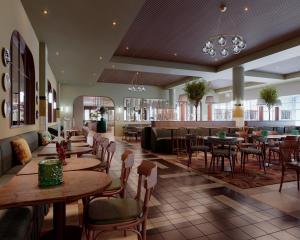 a restaurant with tables and chairs and a bar at Scandic Charlottenburg in Berlin