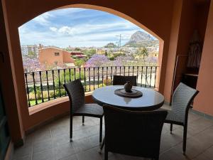a balcony with a table and chairs and a window at BiBi House in Jávea