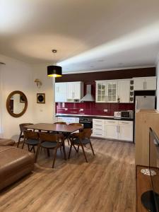 a kitchen and dining room with a table and chairs at Hotel La Cita in Tirana