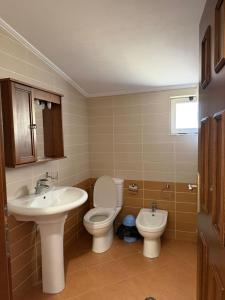 a bathroom with a toilet and a sink at Hotel La Cita in Tirana +49 photos