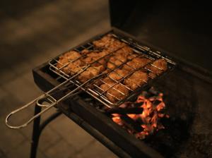a rack of food cooking on a grill at Samudra Retreats Vagamon in Vagamon