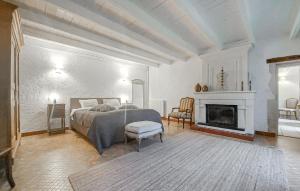 a white bedroom with a bed and a fireplace at Luxueuse Maison Avec Piscine in Cravans +44 photos